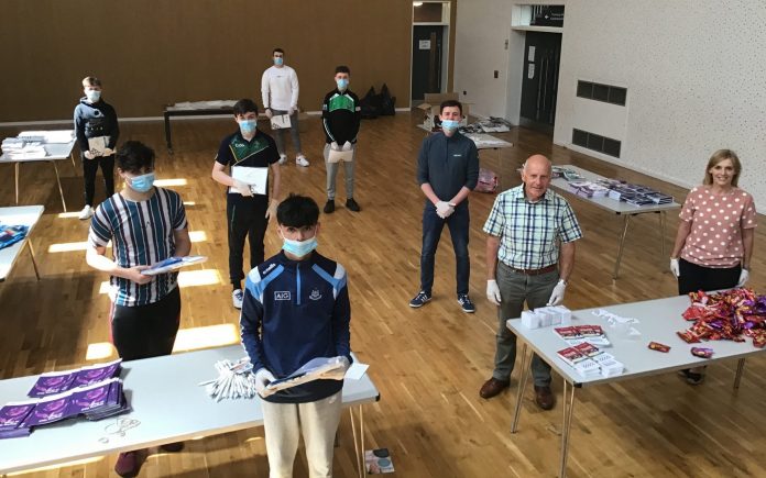 Keady Young Men Older People TMAC ABC Council’s Age-Friendly Officer Stephanie Rock, Caely Donnelly (Young Men’s Development Worker, YouthAction NI) and David Hammerton (Chairperson, ABC Seniors Network) join young men from St. Patrick’s Youth Club Keady Young Men’s Group to help assemble the activity packs for older people across the Borough.