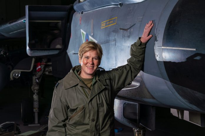 Mandy at aeroplane Picture of woman standing beside a plane