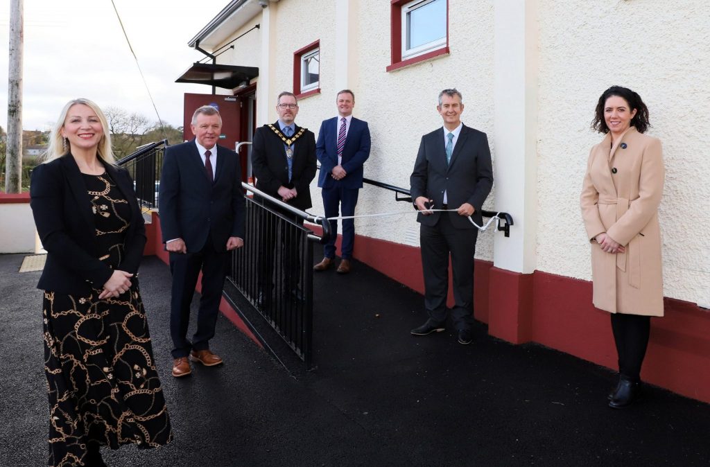 Two women and four men pictured outside a building