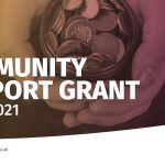 Graphic saying community support grant with a picture of a hand holding coins
