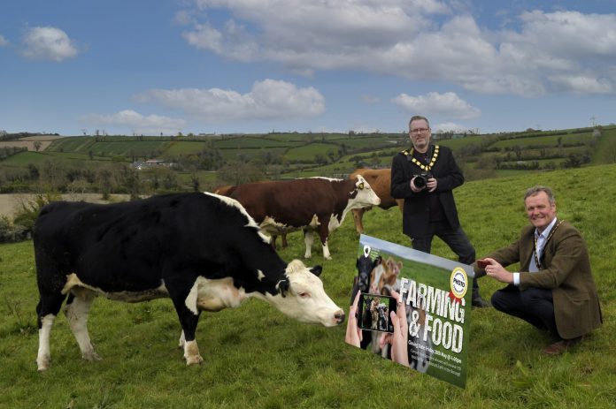 The photo shows the Lord Mayor and Deputy Lord Mayor in a field with cows launching the photographic competition.