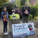 Male Lord Mayor and young girl holding competition prizes - tablets