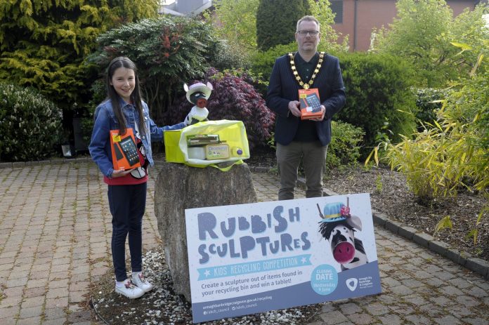 Male Lord Mayor and young girl holding competition prizes - tablets