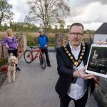 Male Lord Mayor pictured with a female dog walker and male cyclist outside on a path