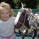 Young girl with horse sculpture