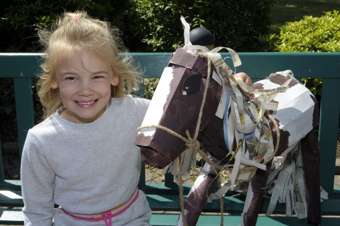 Young girl with horse sculpture