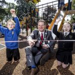 The Lord Mayor cuts the ribbon to officially open Edenvilla Play Park with two children cheering