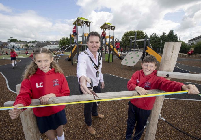 Lord Mayor cuts the ribbon with two pupils to officially open Markethill PLay Park