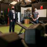 Two males standing indoors in gym