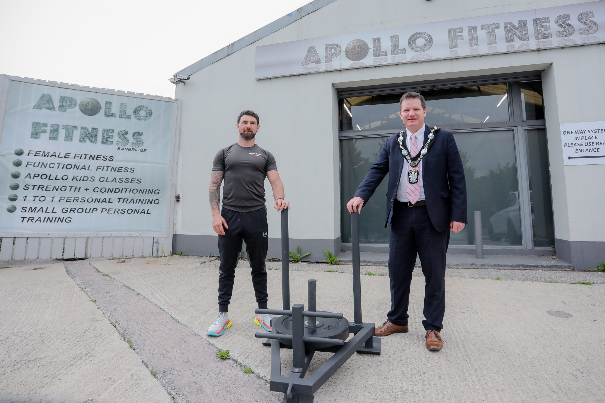 Two males standing outside Apollo fitness