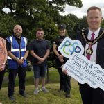 The Lord Mayor is pictured with other representatives holding a PCSP sign to launch a guide on reporting ASB.