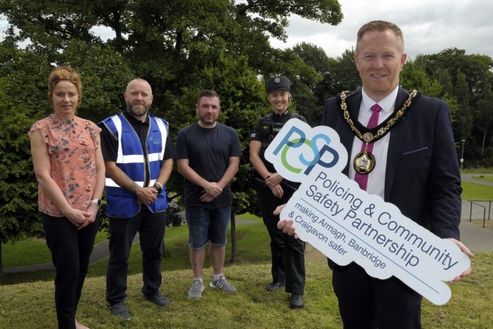The Lord Mayor is pictured with other representatives holding a PCSP sign to launch a guide on reporting ASB.
