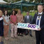 The photo shows the Lord Mayor holding a Tak£500+ board with other representatives launching the new project.