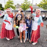 Local family beside performers at Portadown Pop up market
