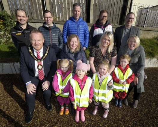 Brian McGivern (Farrans); Lord Mayor, Councillor Paul Greenfield; David Leemon (ABC Council); Gillian Dewart (ABC Council); Gareth Wilson (Farrans); Bryan Orr (ABC Council; Councillor Jill Macauley; Councillor Kevin Savage; and Joan Noade (ABC Council) with children from St. Coleman’s PS and All Saints Nursery at opening of newly refurbished Frazer Park Play Park.