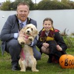 The Lord Mayor is pictured with his daughter dressed as Harry Potter and pet dog with a pumpkin saying the word boo.