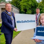 The Lord Mayor, Councillor Paul Greenfield and Safeguarding Coordinator Gary Scott hold a banner with the hashtag #BeSafeOnline while Lucia Greene holds a laptop with the same hashtag.