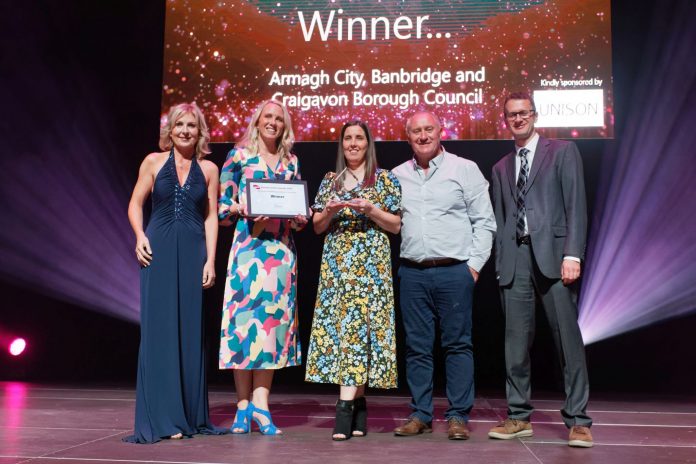 1. Pictured collecting the award, Vice Chair, Leisure & Community Services Committee, Councillor Declan McAlinden and Community Sports Development Officers, Clare Weir and Roisin O’Hagan with awards host Sian Lloyd and representative from category sponsor, Unison.
