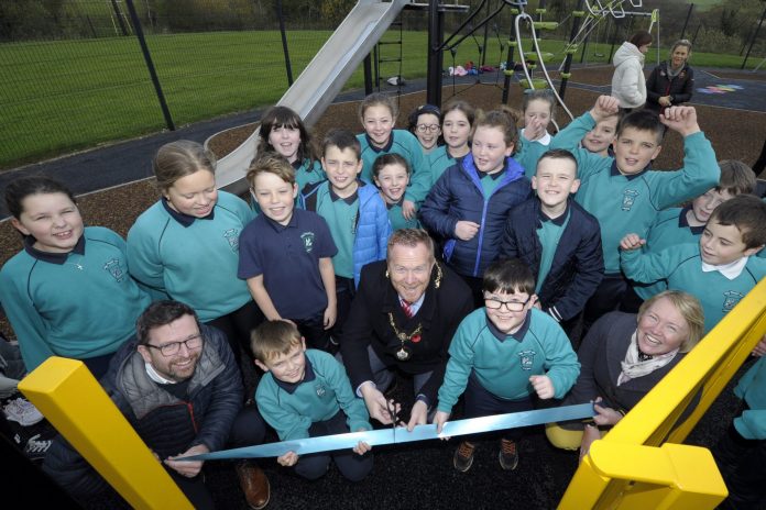 Lord Mayor of Armagh City, Banbridge and Craigavon, Councillor Paul Greenfield cuts the ribbon to officially launch newly refurbished Drumbreda Play Park in Armagh – much to the delight of students from nearby St Patrick’s P.S.