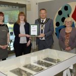 The Lord Mayor and members of staff from FE McWilliam Gallery holding a certificate with 4 stars from Tourism NI