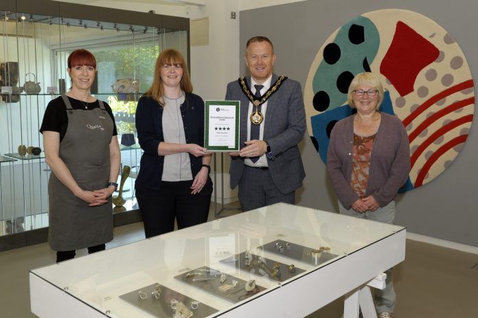 The Lord Mayor and members of staff from FE McWilliam Gallery holding a certificate with 4 stars from Tourism NI