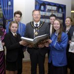 Lord Mayor, Councillor Paul Greenfield and Dolores Donnelly, Community Development Officer present copies of the Great Famine Education Programme booklet to Miss Caitlin Seeley, St. John the Baptist College and Mr Andrew Chambers, Killicomaine Junior High School along with pupils from both schools.