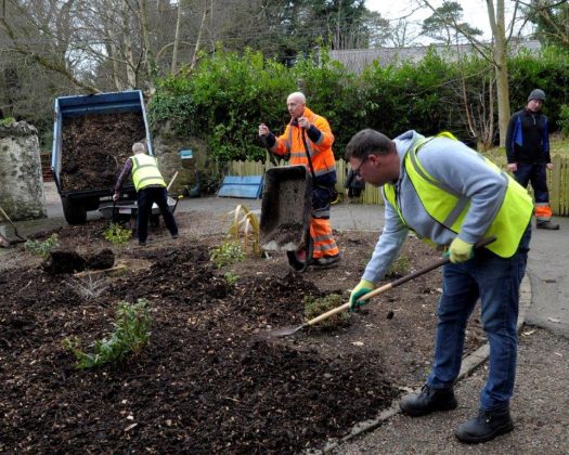 Growing Skills Programme participants pictured applying bark mulch to flower beds at Tannaghmore Gardens, Craigavon.