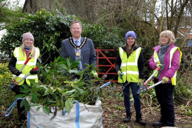 Lord Mayor Greenfield helps participants cut back shrubbery at Tannaghmore Gardens, Craigavon during a recent Growing Skills session.