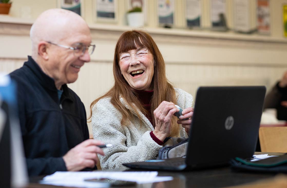 Older man and woman using laptop computer