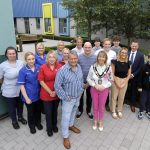 The photo shows a variety of people standing in the new garden at Blossom Children's Ward
