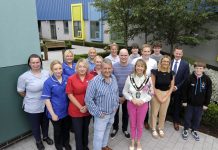 The photo shows a variety of people standing in the new garden at Blossom Children's Ward