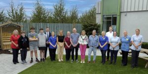 The Lord Mayor with a group of people standing in the new garden at Blossom Children's Ward. 