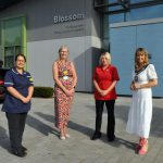 Four females standing outside a hospital building