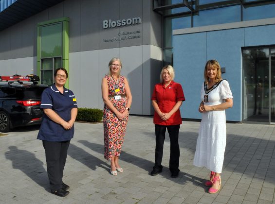 Four females standing outside a hospital building