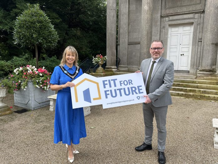Fit For Future Scheme (2) Male and female standing outside with a prop.