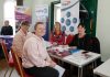 Four women sitting around a table at the job fair