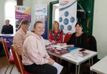 Four women sitting around a table at the job fair