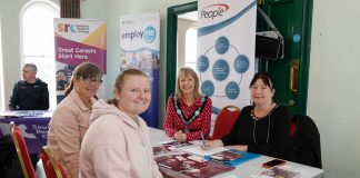 Four women sitting around a table at the job fair