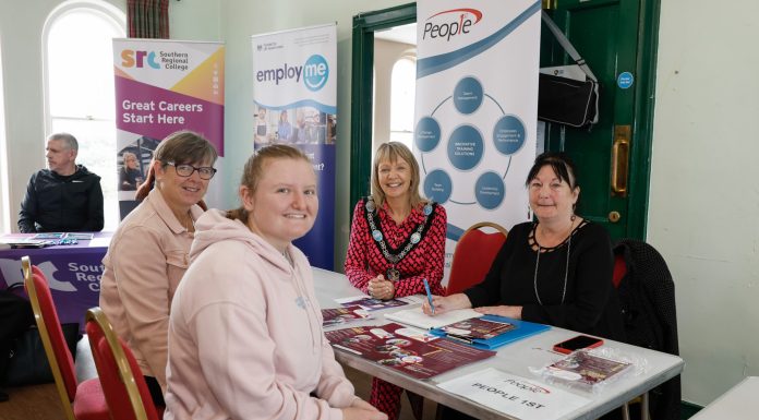 Four women sitting around a table at the job fair