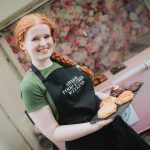 Girl showing a plate of local food at Food and Cider Market