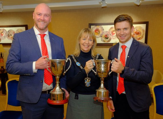 Two males and a female at civic reception.