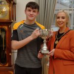 Male and female holding trophy