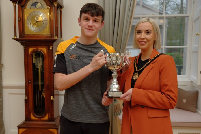 Male and female holding trophy