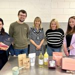 Four local food producers standing with the Lord Mayor showing their products.