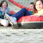 three children enjoying the snow tubing at Craigavon golf and ski centre