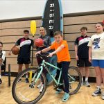Group of people holding sports equipment to promote the getactiveabc summer activities.