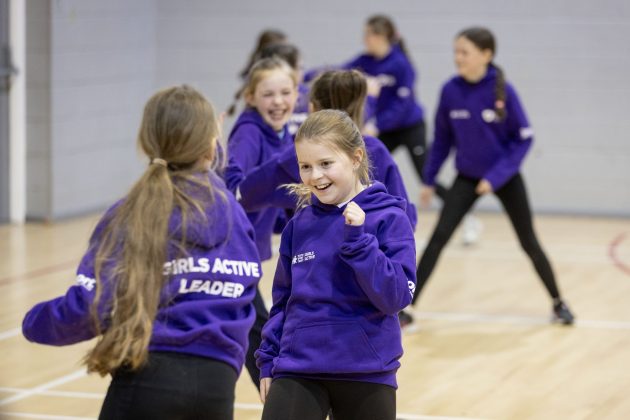 Two young girls dancing.