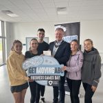 A group of people holding a sign saying Get Moving ABC Business Games Day