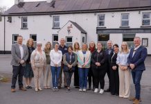 A large group of people stand outside The Halfway House in Banbridge.