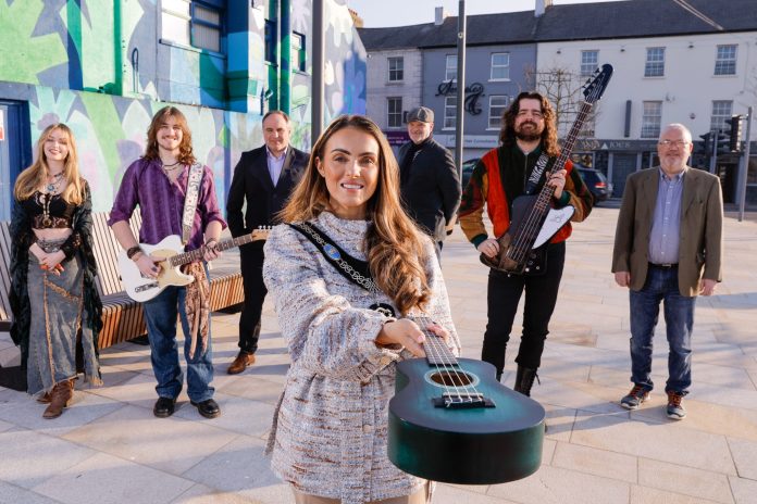 The countdown to Buskfest, taking place on Saturday 14 June 2025, has officially begun Group of males and females standing outside holding musical instruments